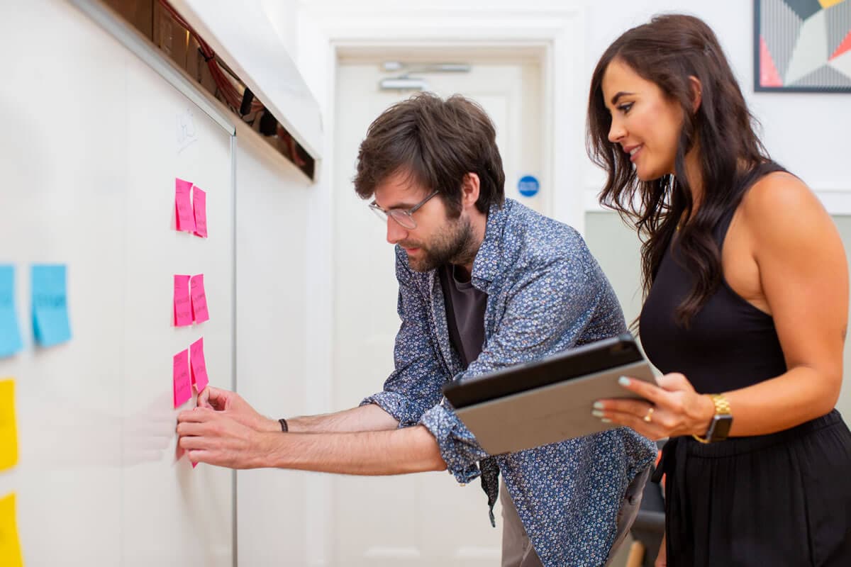 Core team members working on a kanban board